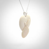 This is a hand carved love heart with love fingers made from bone with sterling silver bale and provided with a sterling silver chain.